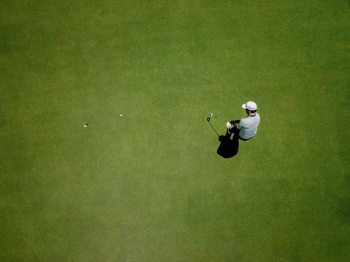 Overhead view of a golfer on the green