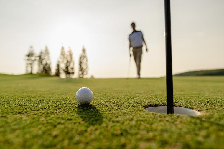 A golfer reading a putt